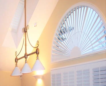 Southern California arched eyebrow window with white shutter